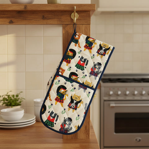 A pair of Scottish themed double oven gloves featuring various designs including animals and tartan patterns.