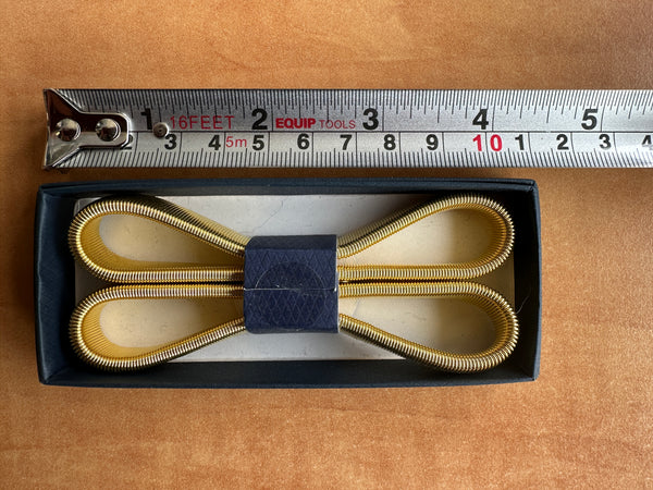 Gold arm bands in a black presentation box 