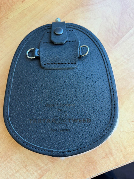 A traditional Scottish dress sporran made from sealskin with a black leather targe with Celtic cantle. Our brand name is embossed on the back.