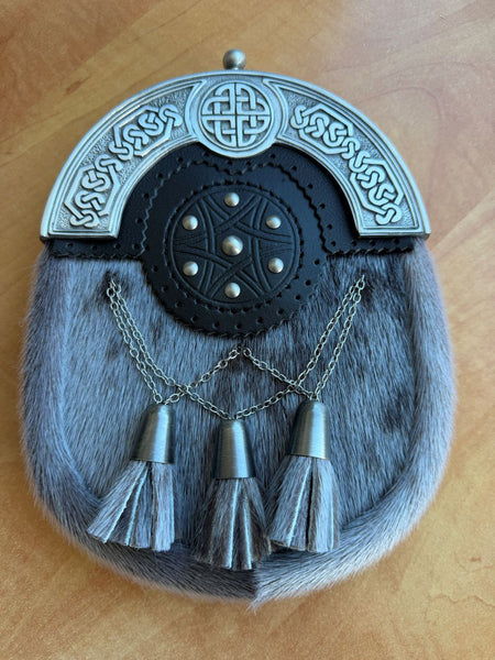 A traditional Scottish dress sporran made from sealskin with a black leather targe with Celtic cantle 